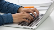 Image of hands typing on a computer